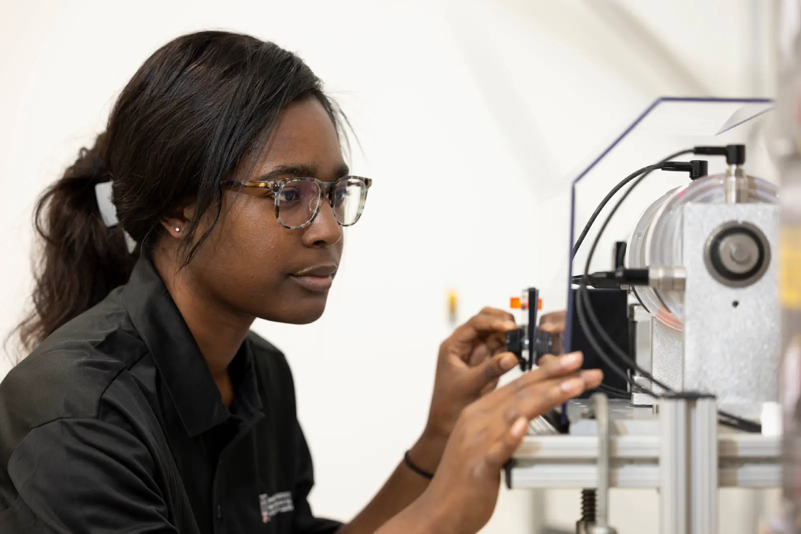 A student tinkering with a machine